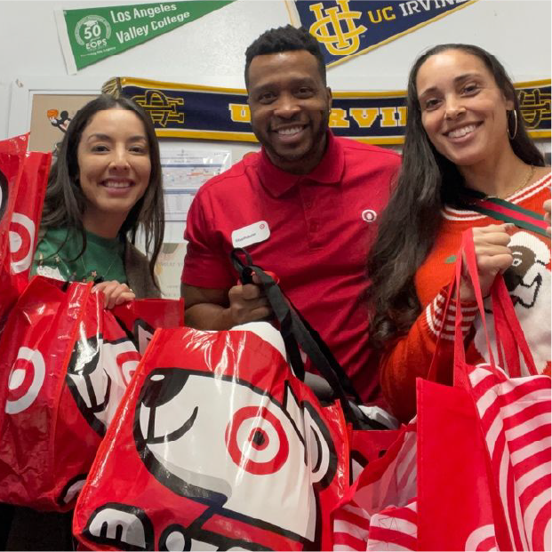 Target team members holding shopping bags.