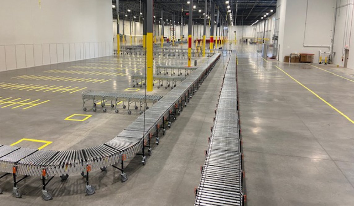 a large warehouse with several conveyor belts