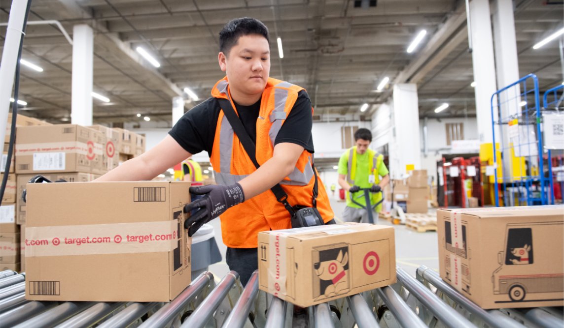 a person in an orange vest in a warehouse