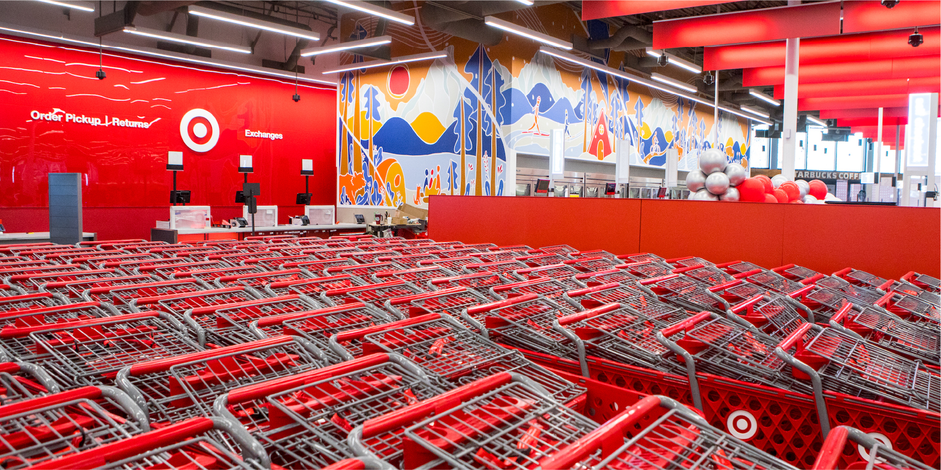 a large room with red seats and a large red wall with a blue and white banner