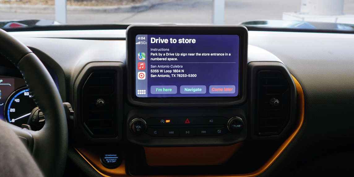 A CarPlay interface in a vehicle displays the "Drive to store" screen in the Target app.